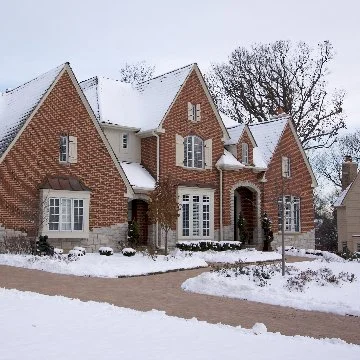 Brick house covered in snow in Ada, MI.