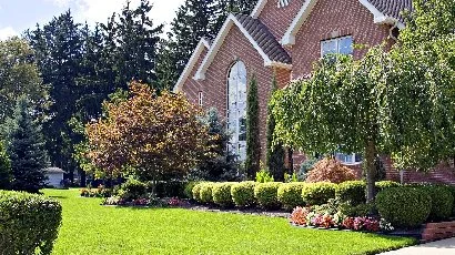Woods Landscape Maintenance box truck at customer's home.