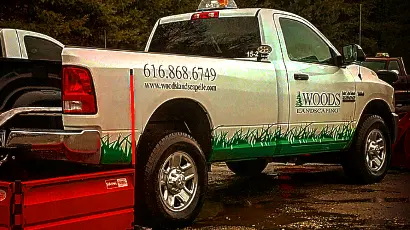 Woods Landscape Maintenance employees working.